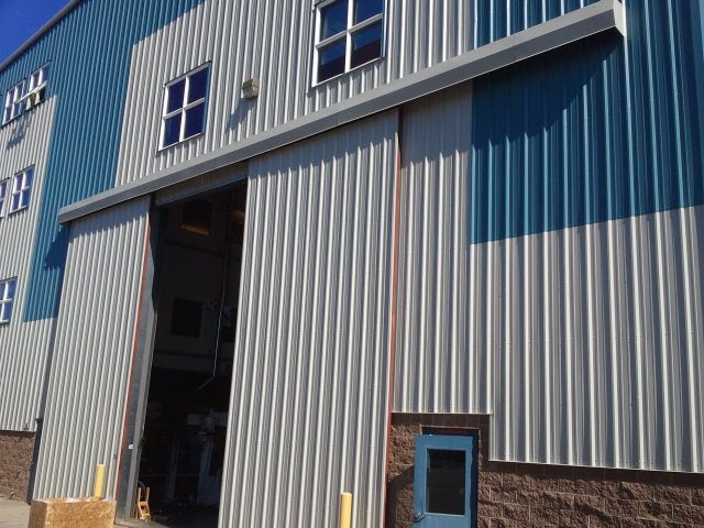 Close-up of a large steel building overhead door and entrance