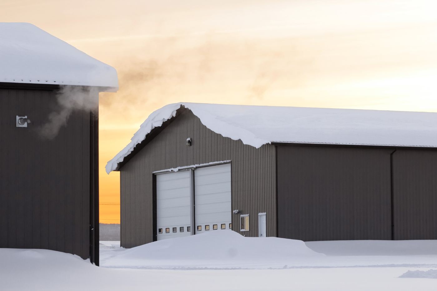 Dark steel buildings engineered for snowy northern conditions